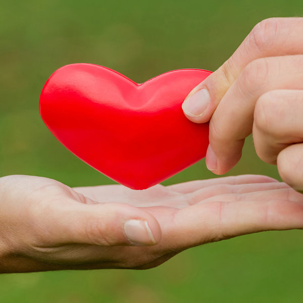 Eine Hand gibt ein rotes Herz in die andere Hand - Copyright: Foto: Wodicka
