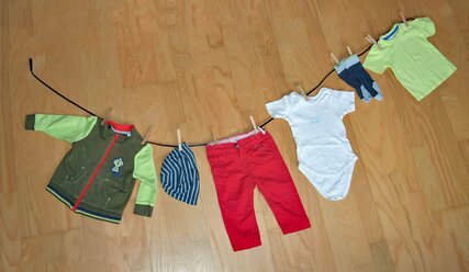 Wäscheleine, an der Kinderkleidung befestigt ist - Copyright: Daniela Steinke
