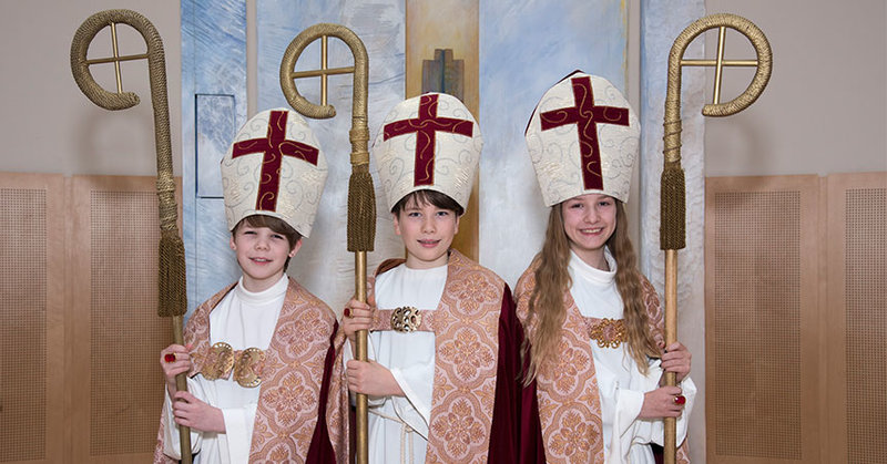 Die drei neuen Kinderbischöfe bei der Anprobe ihrer Amtskleidung